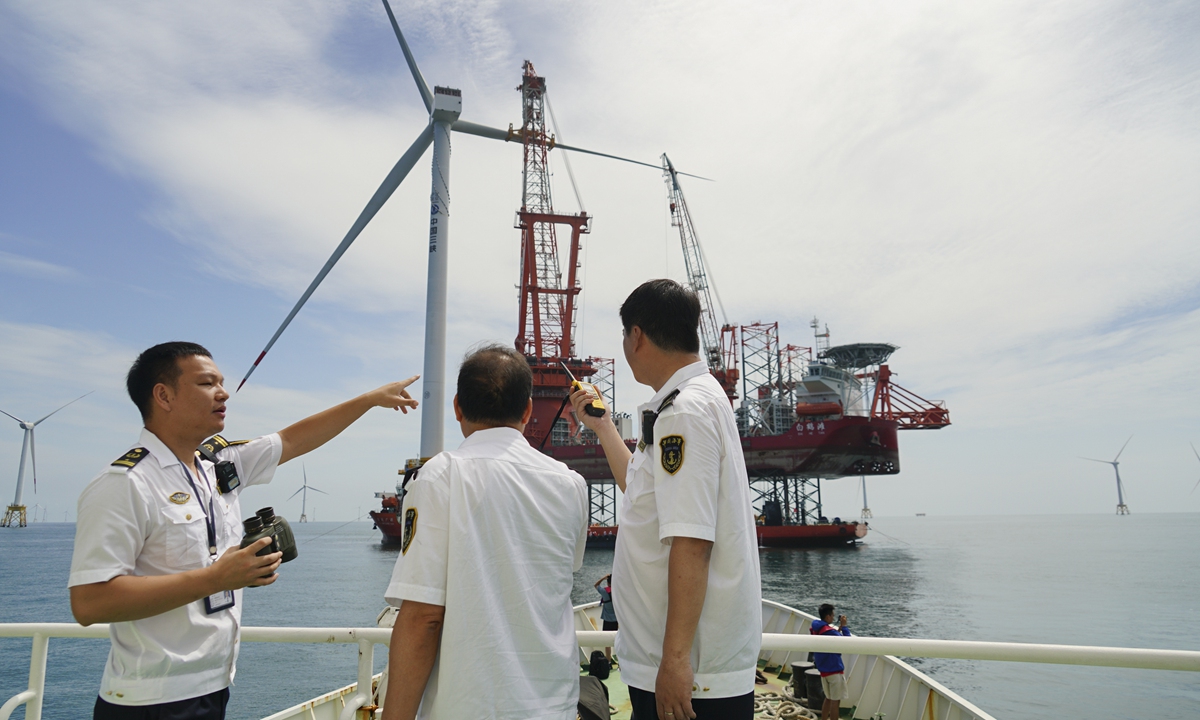 Officers from the Fujian Maritime Safety Administration oversee the 16-megawatt offshore wind turbine on a marine patrol ship on June 28, 2023. Photo: Zhu Sheng