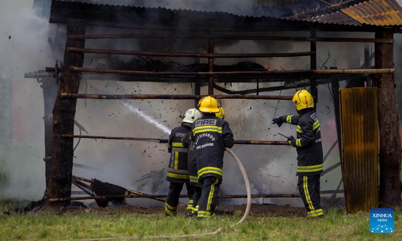 Firefighters try to put out the fire during a fire drill in Kathmandu, Nepal, July 2, 2023. (Photo by Sulav Shrestha/Xinhua)