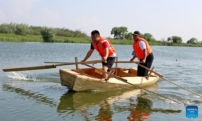 Hezhe people take part in a boat race during the 11th Wurigong Festival of the Hezhe ethnic group in Fuyuan, northeast China's Heilongjiang Province, July 2, 2023. The festival kicked off in China's easternmost city Fuyuan on Sunday. Members of 15 teams from Beijing, Harbin, Jiamusi, Shuangyashan and other places took part in the event.
 (Xinhua/Zhang Tao)