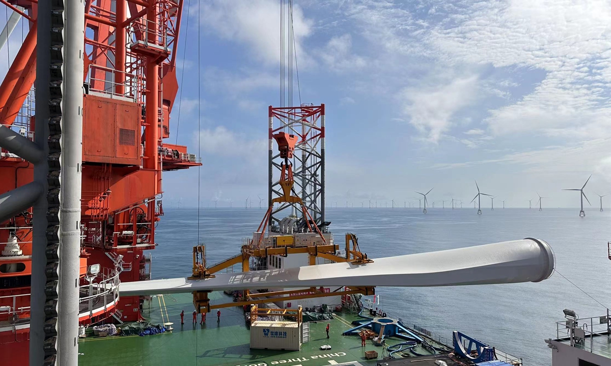 Technicians use a crane to hoist a blade to be mounted on the 16-megawatt offshore wind turbine on June 28, 2023. Photo: Courtesy of CTG