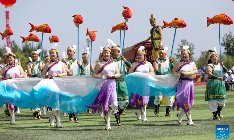 Hezhe people wearing traditional costumes perform during the 11th Wurigong Festival of the Hezhe ethnic group in Fuyuan, northeast China's Heilongjiang Province, July 2, 2023. The festival kicked off in China's easternmost city Fuyuan on Sunday. Members of 15 teams from Beijing, Harbin, Jiamusi, Shuangyashan and other places took part in the event.
 (Xinhua/Zhang Tao)