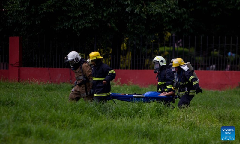 Firefighters rescue an injured person during a fire drill in Kathmandu, Nepal, July 2, 2023. (Photo by Sulav Shrestha/Xinhua)