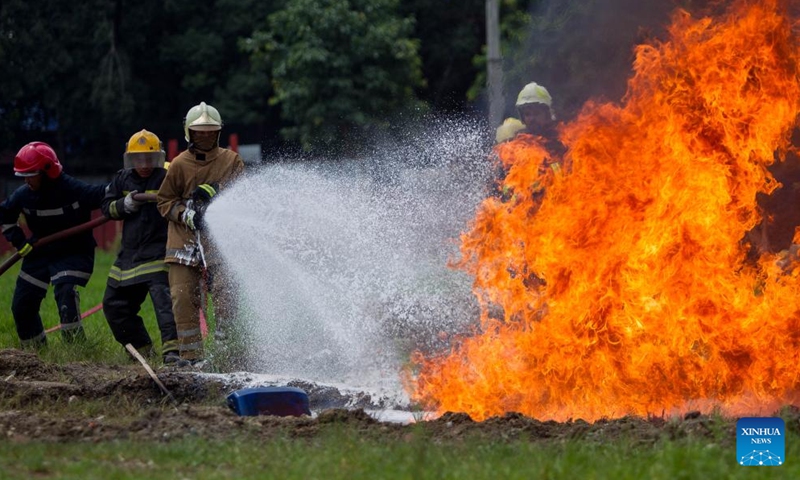 Firefighters try to put out the fire during a fire drill in Kathmandu, Nepal, July 2, 2023. (Photo by Sulav Shrestha/Xinhua)