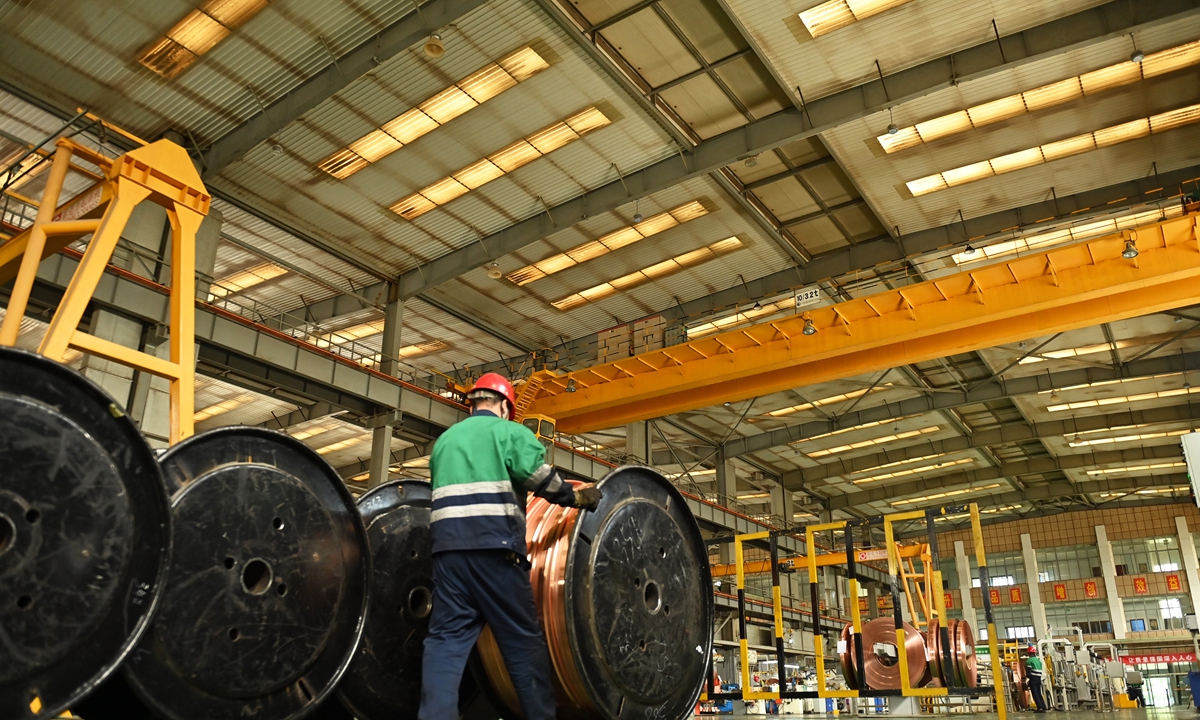 A worker transports special-shaped copper strips, a key component for chip manufacturing, at Jinchuan Nickel Industry Co in Jinchang, Northwest China's Gansu Province, on July 3, 2023. Leveraging the local copper and nickel resources advantage, the company has  formed a copper deep processing industrial cluster, with an annual production of 7,000 tons every year. Photo: VCG