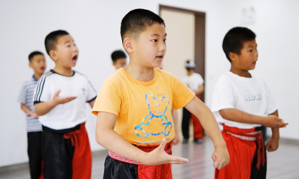 Children practice singing Peking Opera in Nantong, East China's Jiangsu Province, on July 5, 2023. A primary school invited teachers from a local Peking Opera troupe to give the children a weeklong learning experience on the basics of Peking Opera. Photo: VCG