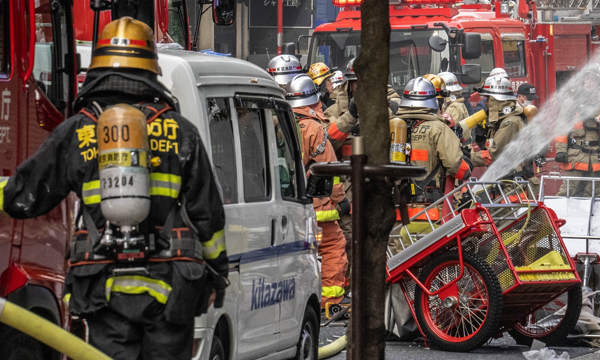 Firefighters work outside a building where there was a an explosion and a fire broke out in the Shimbashi area of Tokyo on July 3, 2023. Four people were injured in the blast, the Tokyo Fire Department said, with glass and debris scattered around the scene as smoke rose from the second floor. The site was said to be filled with gas, with investigators working to confirm further details. Photo: AFP