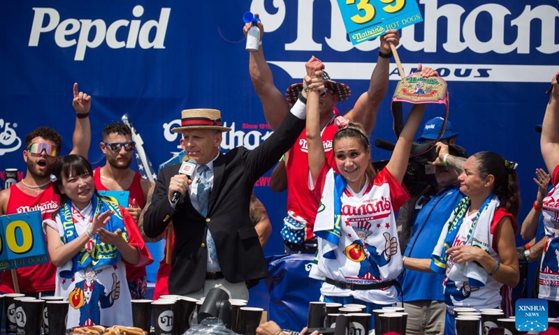 Miki Sudo (2nd R, Front) wins the women's championship of a hot dog eating contest at Coney Island, New York City, the United States, on July 4, 2023. Named the Nathan's Famous Fourth of July International Hot Dog Eating Contest, the annual event has occurred each July 4 on Coney Island since 1916, according to archives. Joey Chestnut, 39, won the first place for the 16th time by eating 62 hot dogs and buns in 10 minutes. ((Photo: Xinhua)