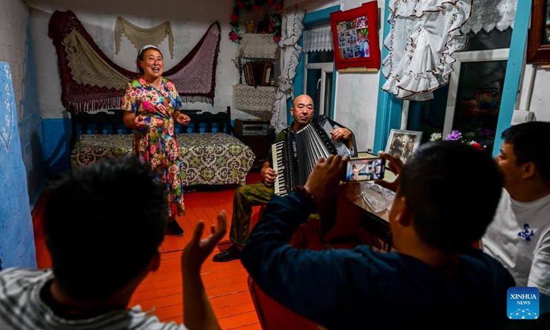 Kao Zhanhua (L) sings for tourists as her brother-in-law plays the accordion in Ergun of Hulun Buir, north China's Inner Mongolia Autonomous Region, June 28, 2023. 57-year-old Kao Zhanhua of the Russian ethnic group, is a representative inheritor of Russian ethnic folk dance, an intangible cultural heritage of Hulun Buir. She has been running a homestay business in her residence with traditional Russian ethnic elements since 2004 and impressed the tourists with its specialties.(Photo: Xinhua)