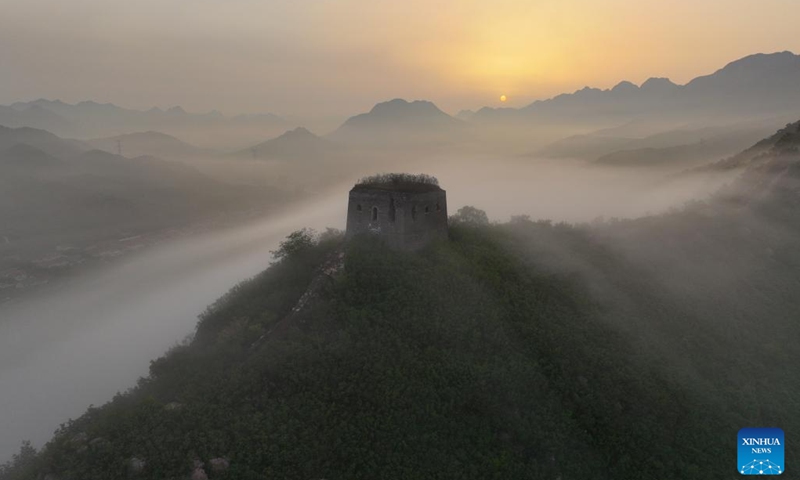 This aerial photo taken on July 5, 2023 shows the Dongjiakou Great Wall shrouded in fog in Qianxi County of Tangshan, north China's Hebei Province.(Photo: Xinhua)