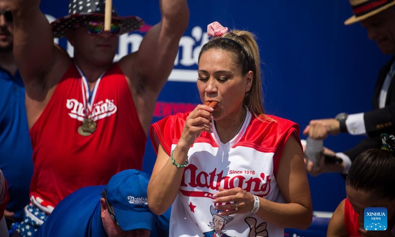 Miki Sudo competes during a hot dog eating contest at Coney Island, New York City, the United States, on July 4, 2023. Named the Nathan's Famous Fourth of July International Hot Dog Eating Contest, the annual event has occurred each July 4 on Coney Island since 1916, according to archives. Joey Chestnut, 39, won the first place for the 16th time by eating 62 hot dogs and buns in 10 minutes.((Photo: Xinhua)