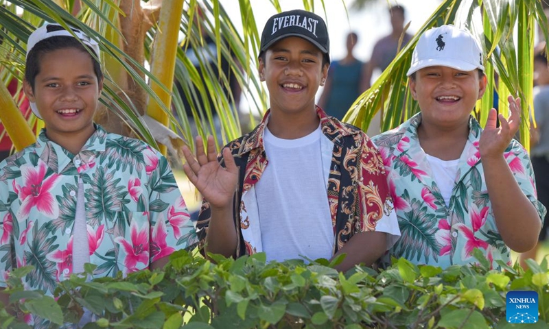 Children wave while watching a float parade in Nuku'alofa, Tonga, on July 4, 2023. Tongan King Tupou VI's official birthday, observed on July 4 each year, is a public holiday in the country.((Photo: Xinhua)