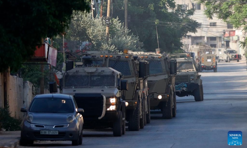 Israeli military vehicles are pictured at a refugee camp in the West Bank city of Jenin on July 3, 2023. The Israeli army launched a large-scale military strike early on Monday on the northern West Bank city of Jenin, according to eyewitnesses and the Israeli military.(Photo: Xinhua)