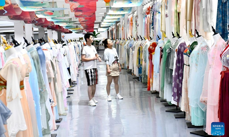 Customers select traditional Chinese Hanfu clothing at a Hanfu base in Caoxian County, east China's Shandong Province, July 6, 2023. Caoxian County has developed a complete Hanfu industrial chain in recent years. At present, there are more than 2,100 Hanfu-related enterprises in the county. The sales of Hanfu in Caoxian reached nearly 4 billion yuan (about 552 million U.S. dollars) in the first half of this year.(Photo: Xinhua)