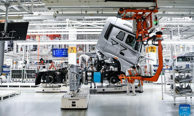 Workers assemble a truck on automatic guided vehicles at an intelligent plant of truck manufacturer First Automotive Works Jiefang Co., Ltd. (FAW Jiefang) in Changchun, northeast China's Jilin Province, June 12, 2023.(Photo: Xinhua)