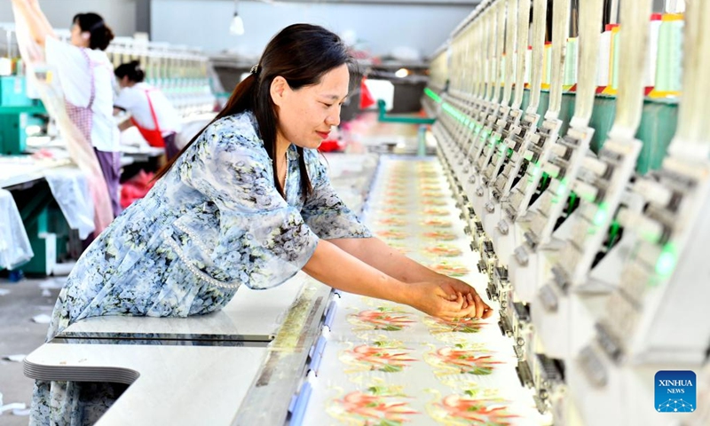 A staff member works at a Hanfu factory in Caoxian County, east China's Shandong Province, July 6, 2023. Caoxian County has developed a complete Hanfu industrial chain in recent years. At present, there are more than 2,100 Hanfu-related enterprises in the county. The sales of Hanfu in Caoxian reached nearly 4 billion yuan (about 552 million U.S. dollars) in the first half of this year.(Photo: Xinhua)