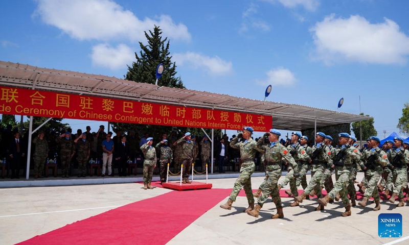 Members of the 21st Chinese peacekeeping contingent parade at the camp of the contigent in Hanniyah village in southern Lebanon, on July 4, 2023. A total of 410 peacekeepers of the 21st Chinese peacekeeping contingent to Lebanon were awarded UN medals of peace on Tuesday for their outstanding commitment to maintaining stability and peace in the south of the country.(Photo: Xinhua)