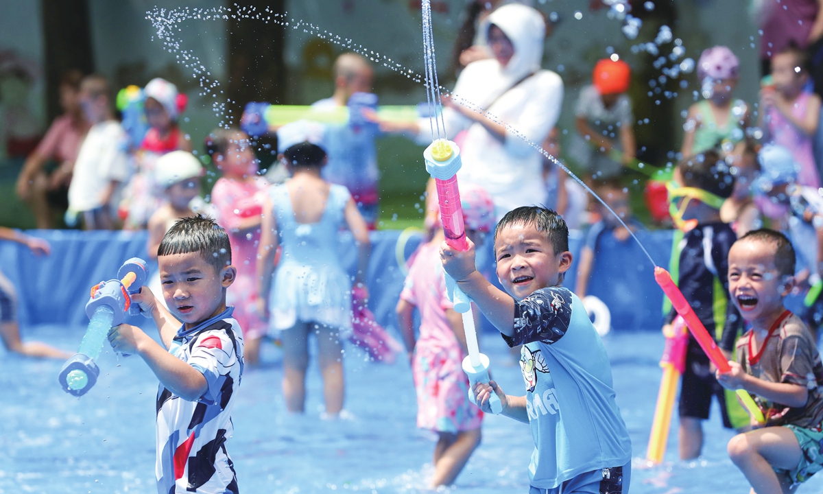 Children play with water guns in a kindergarten in Rongjiang county, Southeast Guizhou Province, on July 6, 2023. Photo: VCG