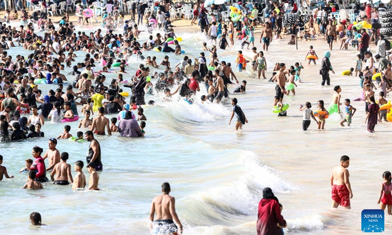 People cool off at a beach of the Mediterranean sea during a heatwave in Alexandria, Egypt, on July 6, 2023.(Photo: Xinhua)