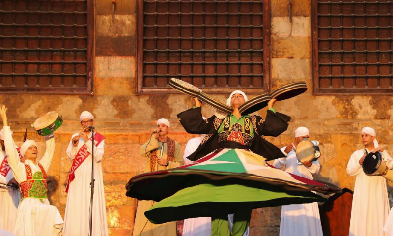 Dancers perform Sufi dance during a summer night at Wekalet El-Ghoury in Cairo, Egypt, July 15, 2023. (Xinhua/Wang Dongzhen)