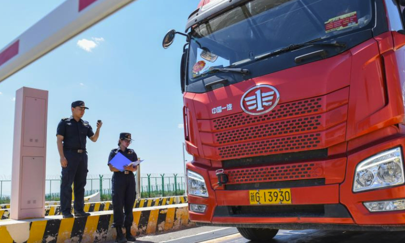 Customs officers check a vehicle leaving the supervision zone at the Bakti port in Tacheng, northwest China's Xinjiang Uygur Autonomous Region, July 22, 2023. Located on the border of China and Kazakhstan, Tacheng has focused on constructing a 40-square-kilometer pilot zone to vigorously develop industries such as new energy equipment manufacturing, import and export of agricultural and sideline products, and other related sectors. Up to now, 63 enterprises have signed agreements to settle in the pilot zone with several projects already in operation. (Xinhua/Ding Lei)