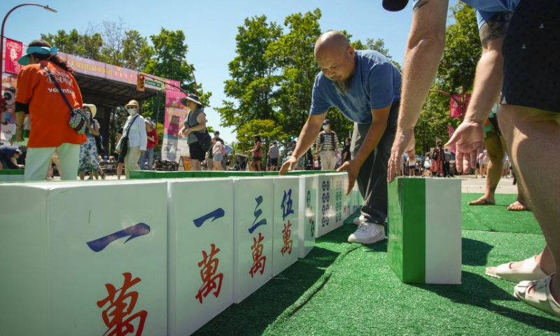 People play with giant mahjong tiles during the 21st Chinatown Festival in Vancouver, British Columbia, Canada, on July 15, 2023. The two-day community family event kicked off on Saturday here. (Photo by Liang Sen/Xinhua)