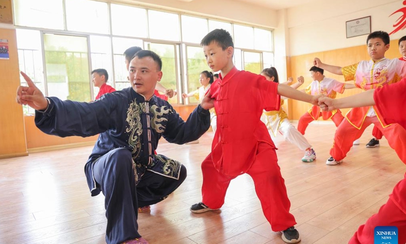 A martial art teacher teaches students in Lanshan District of Linyi, east China's Shandong Province, July 8, 2023. Students around the country enjoy a variety of activities during the summer vacation. (Photo by Xu Chuanbao/Xinhua)