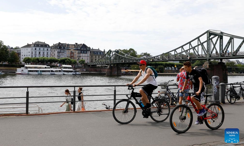 People ride bicycles in Frankfurt, Germany, on July 8, 2023. (Xinhua/Zhang Fan)