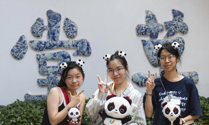 Tourists pose for photos with Rongbao, mascot of the Chengdu Universiade, in Chengdu, southwest China's Sichuan province, July 19, 2023. The 31st International University Sports Federation (FISU) Summer World University Games will be held in Chengdu from July 28 to August 8. (Xinhua/Jiang Hongjing)