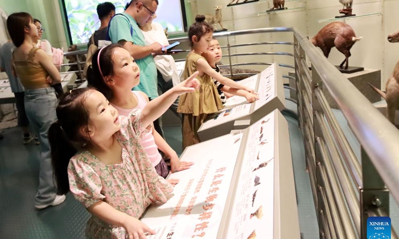 Children view animal specimens at Changzhou Museum in Changzhou, east China's Jiangsu Province, July 8, 2023. Students around the country enjoy a variety of activities during the summer vacation. (Photo by Wang Qiming/Xinhua)