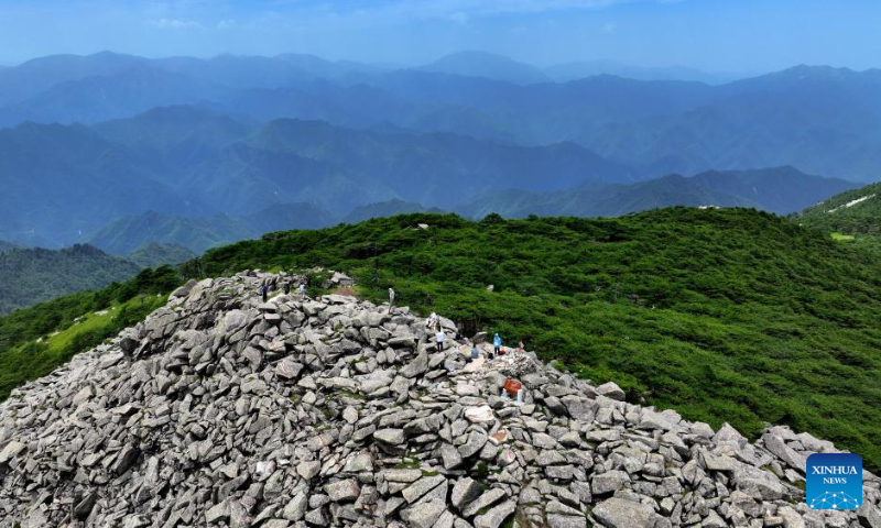 This aerial photo taken on July 21, 2023 shows visitors reaching the Bingjing peak, the highest point of the Zhuque National Forest Park in Xi'an, northwest China's Shaanxi Province. (Xinhua/Liu Xiao)