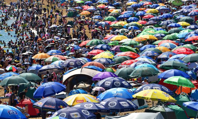 A beach in Dalian, Northeast China's Liaoning Province is crowded with locals and tourists on July 16, 2023. As China is having a scorching summer, the popularity of destinations in northern coastal cities has increased significantly. Photo: VCG