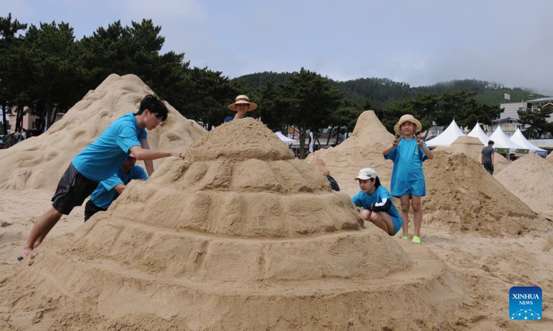 Sand sculpture enthusiasts take part in a sand sculpture festival on Yeonpo Beach in Taean County, South Chungcheong Province, South Korea, July 8, 2023. (Xinhua/Zhou Siyu)