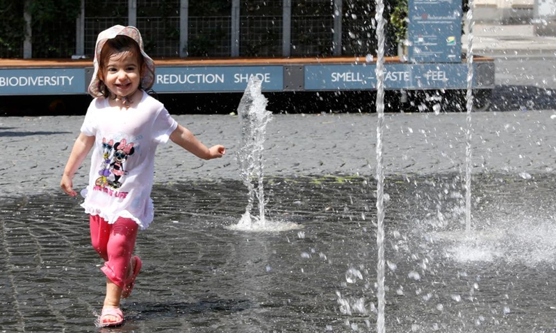 A girl plays at a fountain in Frankfurt, Germany, on July 8, 2023. (Xinhua/Zhang Fan)