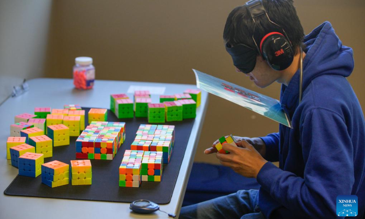 A contestant solves a Rubik's Cube blindfolded during the Canadian Speedcubing Championship 2023 at the Queen's Park Arena in New Westminster, British Columbia, Canada, on July 13, 2023. A total of 320 contestants from 20 countries and regions took part in the championship from July 13 to 16. Photo:Xinhua