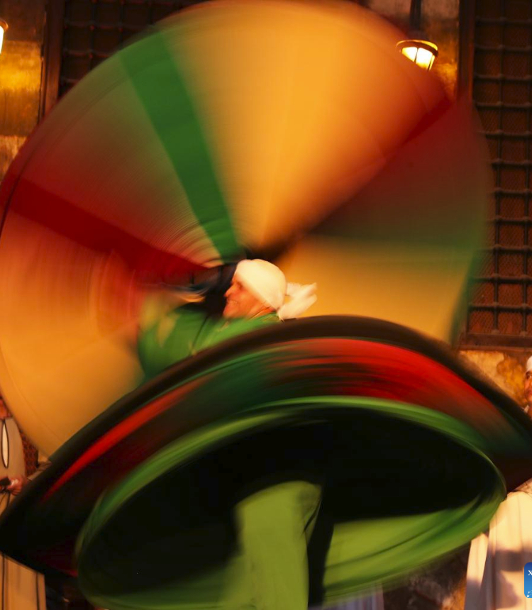 A dancer performs Sufi dance during a summer night at Wekalet El-Ghoury in Cairo, Egypt, July 15, 2023. (Xinhua/Wang Dongzhen)