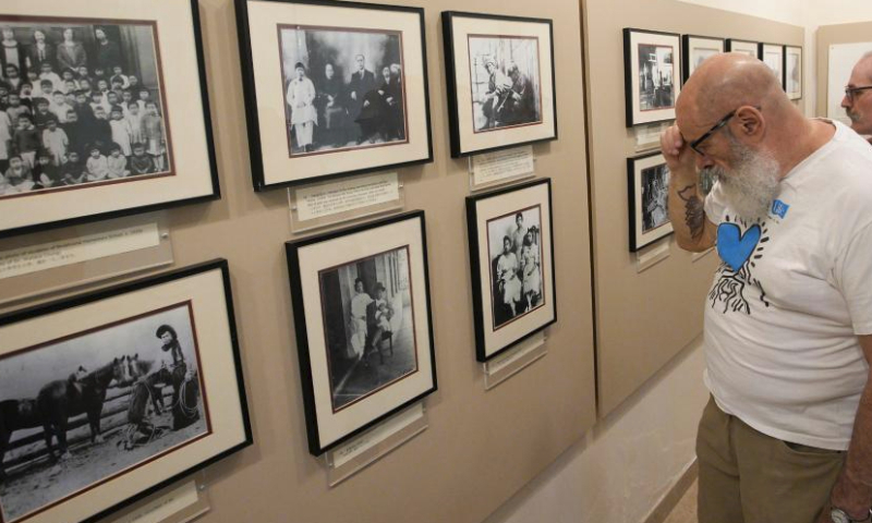 People look at some historical photos of Chinatown during the 21st Chinatown Festival in Vancouver, British Columbia, Canada, on July 15, 2023. The two-day community family event kicked off on Saturday here. (Photo by Liang Sen/Xinhua)