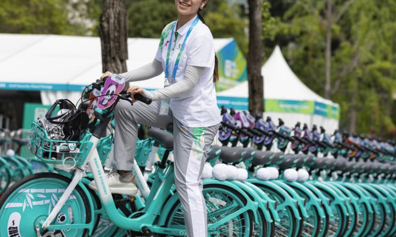 A volunteer rides a shared bicycle customized for the Chengdu Universiade in Chengdu, southwest China's Sichuan province, July 20, 2023. The 31st International University Sports Federation (FISU) Summer World University Games will be held in Chengdu from July 28 to August 8. (Xinhua/Jiang Hongjing)