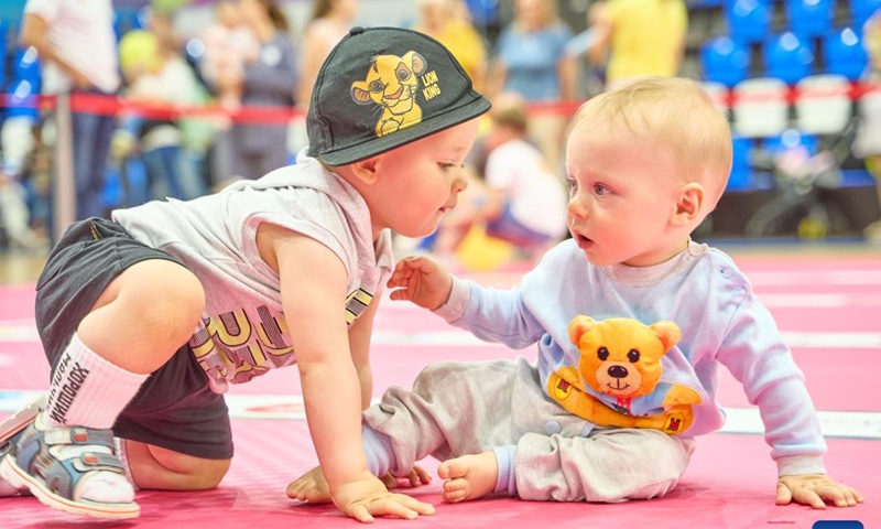 Babies take part in a baby crawling race in Vladivostok, Russia, July 8, 2023. July 8 marks the Day of Family, Love and Fidelity in Russia. A baby crawling race was held in Russia's Far East city of Vladivostok to celebrate the occasion. (Photo by Guo Feizhou/Xinhua)