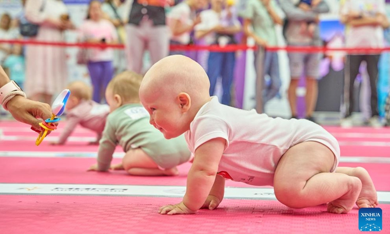 Babies take part in a baby crawling race in Vladivostok, Russia, July 8, 2023. July 8 marks the Day of Family, Love and Fidelity in Russia. A baby crawling race was held in Russia's Far East city of Vladivostok to celebrate the occasion. (Photo by Guo Feizhou/Xinhua)