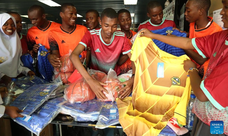 Tanzanian athletes check out sports equipment donated by China at the handover ceremony in Dar es Salaam, Tanzania, July 10, 2023. China on Monday donated sports equipment to Tanzania to motivate young people to develop their talents.(Photo: Xinhua)