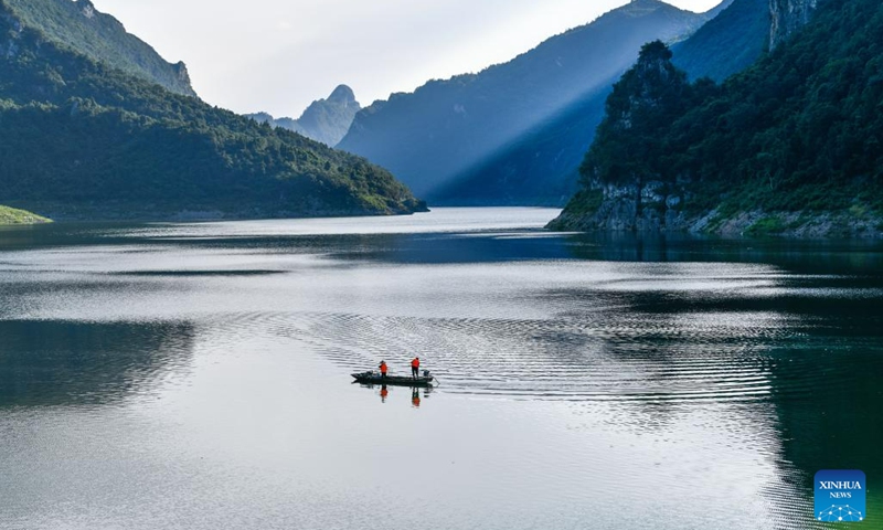 Lu Xiyong and Ran Maoying clean up floating garbage on the Wujiang River in Zhucang Township of Weng'an County, southwest China's Guizhou Province, July 10, 2023. Lu and Ran are local villagers who grew up along the Wujiang River and got married in 1986. For decades, the couple took the initiative to clean up the floating garbage along the Wujiang River and promote environmental protection while working on ferries.(Photo: Xinhua)