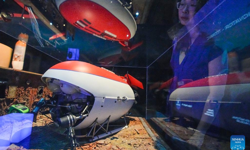 A visitor looks at a submarine model for filming Titanic during James Cameron-Challenging the Deep exhibition at Science World in Vancouver, British Columbia, Canada, on July 10, 2023. James Cameron-Challenging the Deep is an immersive exhibition that showcases the filmmaker's achievements and innovations in deep-sea exploration and filmmaking.(Photo: Xinhua)