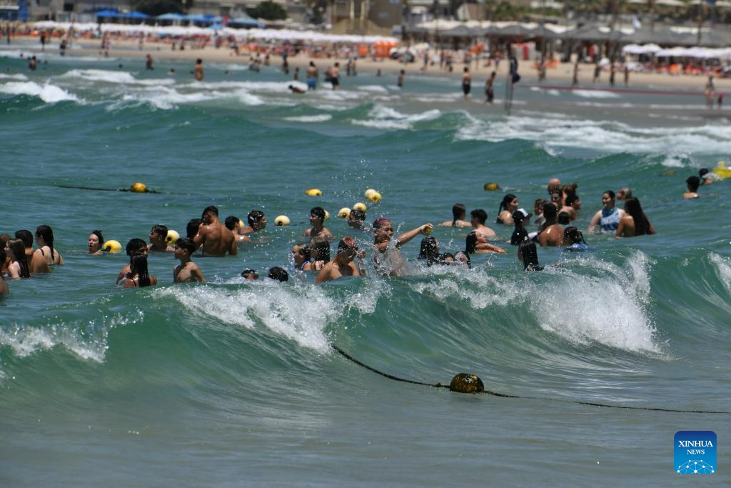 People cool themselves in the sea by a beach in Tel Aviv, Israel, July 12, 2023.(Photo: Xinhua)