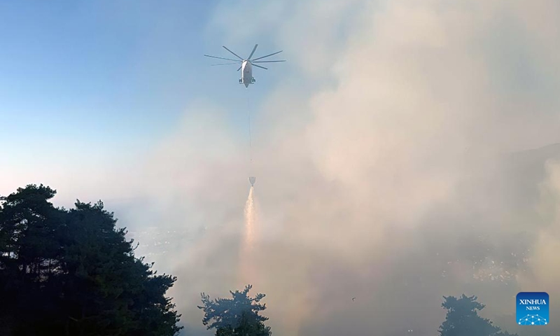 A helicopter works on containing a wildfire in Belen District of Hatay Province, Türkiye, July 17, 2023. Wildfires broke out in the southern and western provinces of Türkiye over the weekend as summer heat grips a large swathe of the country, local media reported on Monday(Photo: Xinhua)