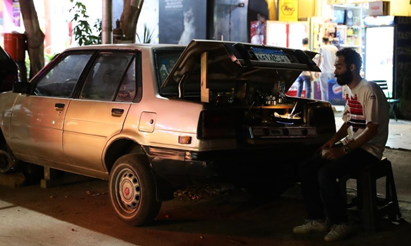 A man makes coffee at his street car cafe in Cairo, Egypt, July 25, 2023. (Xinhua/Wang Dongzhen)