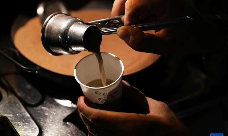 A man makes coffee at his street car cafe in Cairo, Egypt, July 25, 2023. (Xinhua/Wang Dongzhen)