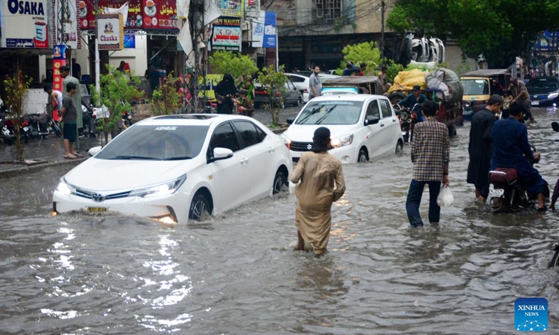 Vehicles move on a flooded road after heavy monsoon rain in southern Pakistan's Hyderabad, July 23, 2023. (Str/Xinhua)