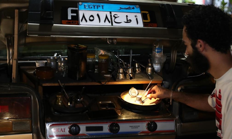 A man makes coffee at his street car cafe in Cairo, Egypt, July 25, 2023. (Xinhua/Wang Dongzhen)