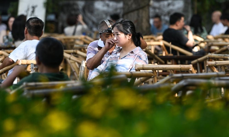 A visitor experiences the unique ear-cleaning in Chengdu of southwest China's Sichuan Province, on July 14, 2023. The 31st FISU Summer World University Games is scheduled to take place in Chengdu from July 28 to August 8, 2023. (Xinhua/Wang Xi)