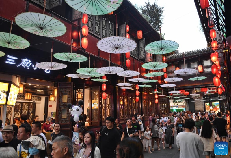 Tourists visit the Jinli folklore street in Chengdu of southwest China's Sichuan Province, on July 14, 2023. The 31st FISU Summer World University Games is scheduled to take place in Chengdu from July 28 to August 8, 2023. (Xinhua/Liu Kun)